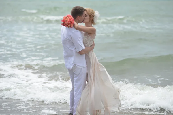 Поцелуи свадьбы пара на пляже — стоковое фото