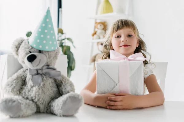 Happy Birthday Kid Sitting Present Table Teddy Bear Cone — стоковое фото