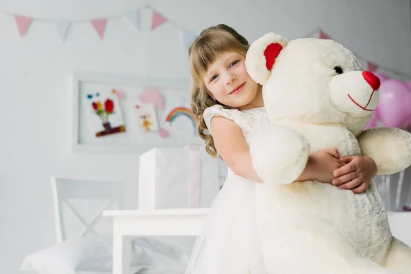 Happy Birthday Kid White Dress Embracing Teddy Bear — стоковое фото