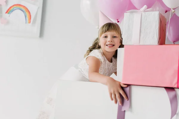 Happy Birthday Kid Cone Looking Camera Holding Gift Boxes — стоковое фото