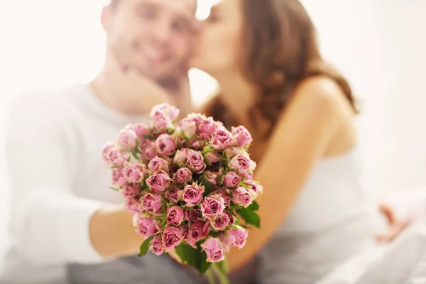 Человек, давая цветы к женщине в постели — стоковое фото