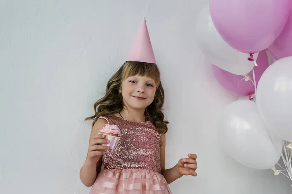 Happy Birthday Child Cone Dirty Nose Holding Cupcake Pink Balloons — стоковое фото